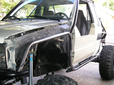 1986 Toyota Hilux - This heavily modified pickup truck features extensive roll cage and suspension upgrades for off-road use.