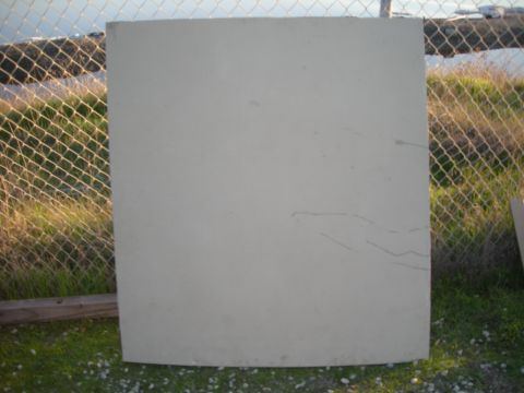 1991 Ford Bronco - A car hood is shown outdoors, leaning against a fence with grass and gravel visible.