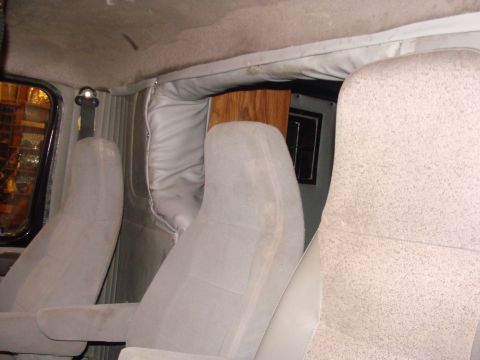 1992 Ford Bronco - Interior view shows light grey seats and grey upholstery, with a wooden panel visible in the background.