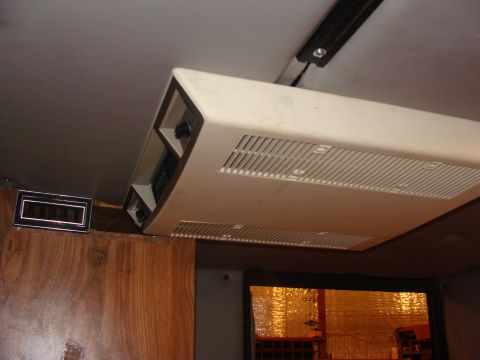 1992 Ford Bronco - Interior shot of an RV showing the ceiling-mounted air conditioner and a digital clock.