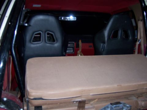 1991 Ford Bronco - The interior features racing-style front seats and a folded rear seat, with a view towards the dashboard.