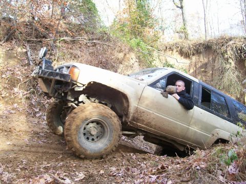 2007 Jeep Wrangler - A driver navigates a challenging off-road course with their modified SUV, getting stuck in the mud.