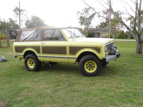 1994 Ford Bronco - This vintage SUV features a distinctive two-tone paint scheme with wood grain accents on its side panels.
