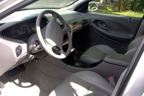 1998 Ford Taurus - The interior of a 1998 Ford Taurus, tan upholstery and dashboard details.