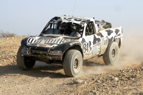 2008 Ford Bronco - This off-road race truck, number 84, features a distinctive 'got milk?' livery and is seen competing on a dusty track.
