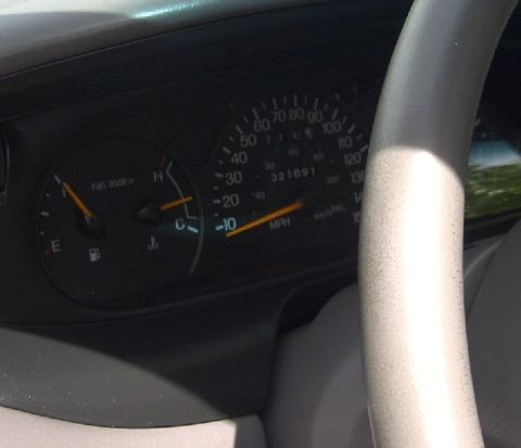 1998 Ford Taurus - Interior view of a car's dashboard, a speedometer and fuel gauge.