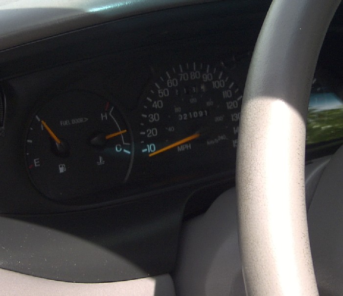 Car dashboard showing speedometer, fuel gauge, and odometer reading 321091. Steering wheel is partially visible
