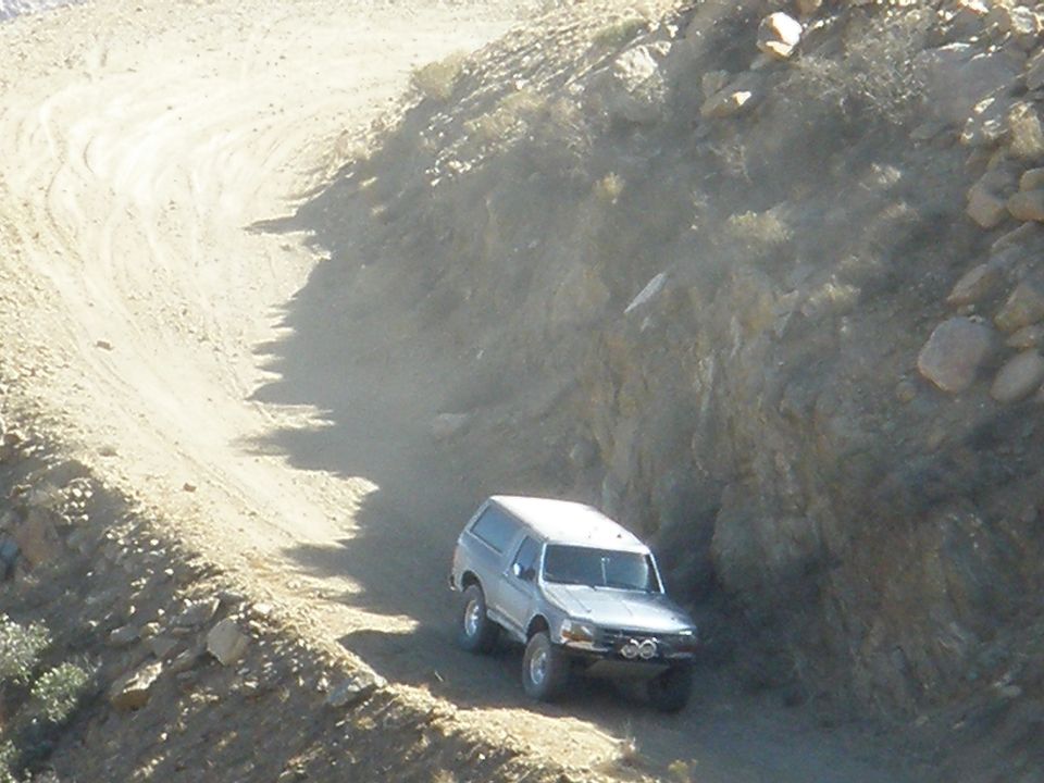 Silver SUV on dusty dirt road, 1992 body style