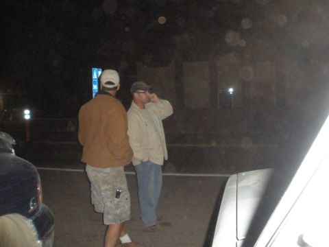 2008 Ford Bronco - Two men are standing on a street at night, with a car partially visible in the foreground.