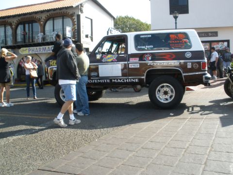 2008 Ford Bronco - A brown and white SUV, likely a Chevrolet K5 Blazer, is seen with various racing decals and sponsor logos, including 'ROSEMITTE MACHINE'.