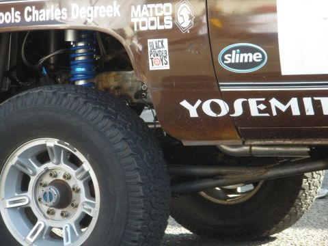 2008 Ford Bronco - Off-road truck with racing decals, including 'YOSEMITI' and 'SLIME', seen from the side.