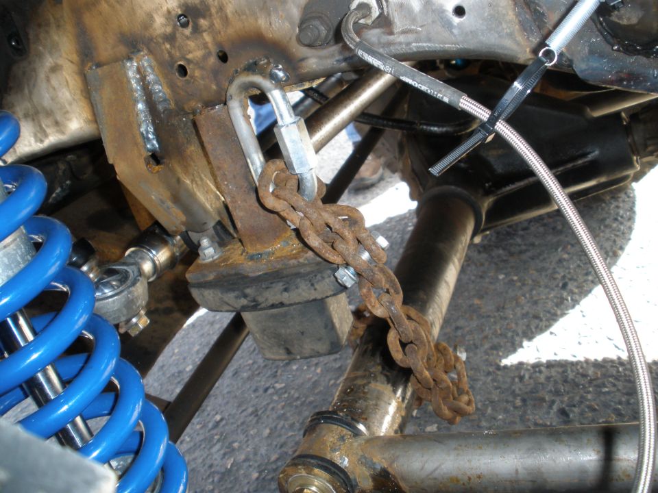 Modified suspension part with blue coilover and rusty chain