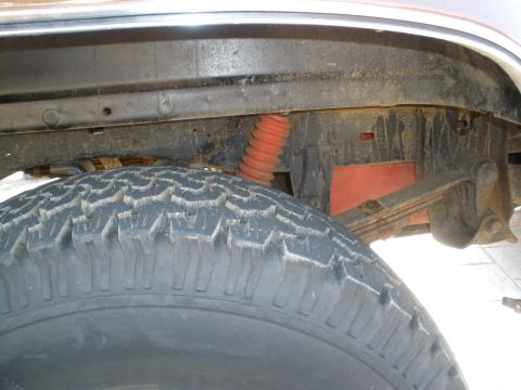 2008 Ford Bronco - Close-up view of a vehicle's undercarriage, showing the tire and suspension system.