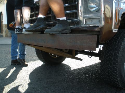 2008 Ford Bronco - People stand on a custom metal bumper attached to a truck.