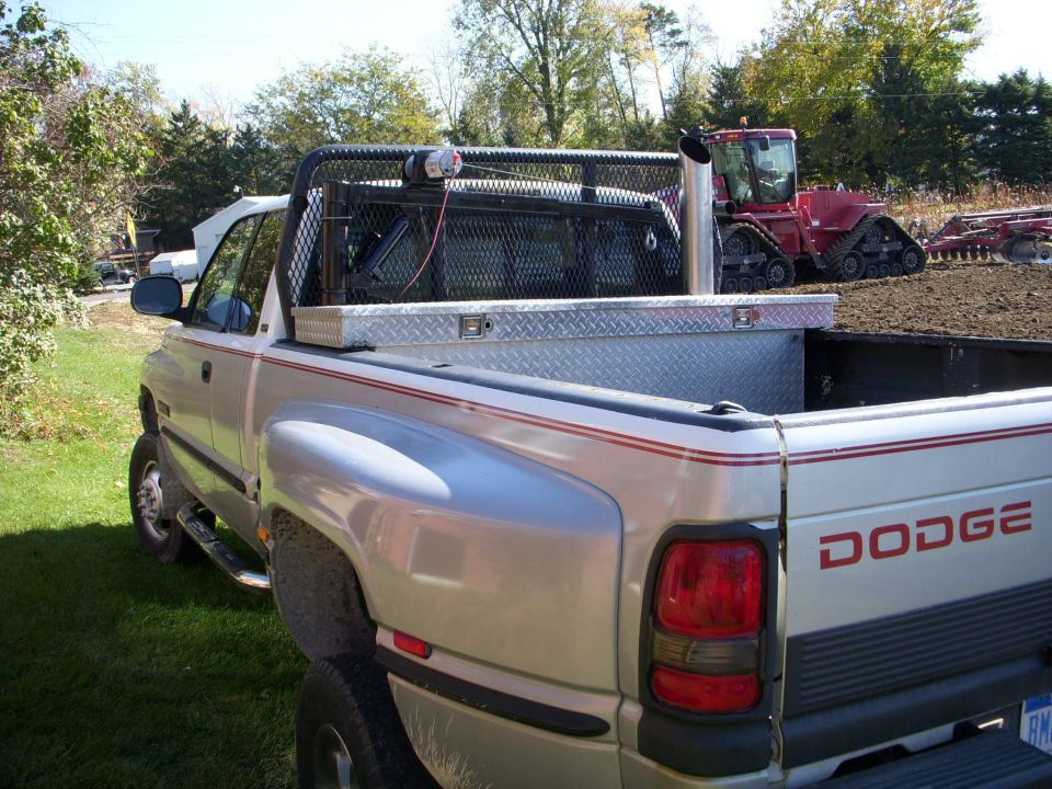 Silver Dodge pickup truck rear view with red pinstripes and toolbox