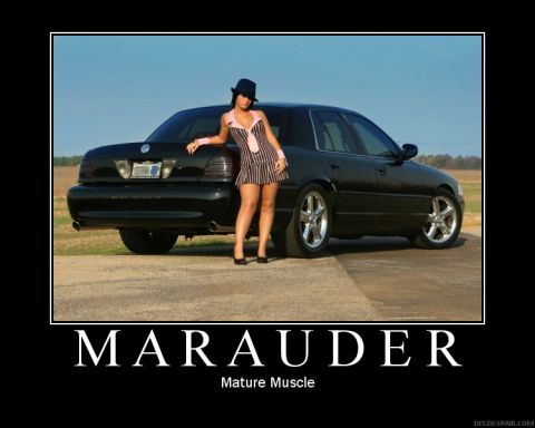 2003 Mercury Marauder - A woman poses next to a black 2003 Mercury Marauder sedan.