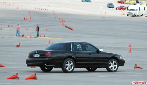 2003 Mercury Marauder - A black 2003 Mercury Marauder is seen on a race track, navigating through a course marked by orange cones.
