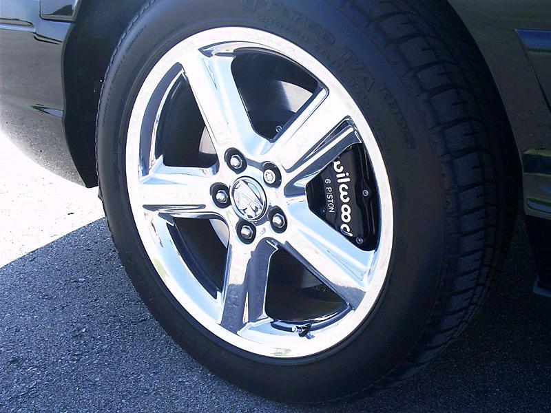 Close-up of a chrome wheel with a black Wilwood 6 Piston brake caliper