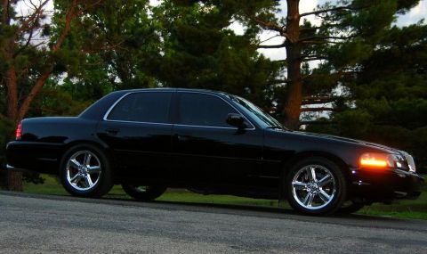 2003 Mercury Marauder - A black 2003 Mercury Marauder is shown from a 3q-front angle, parked on a roadside.