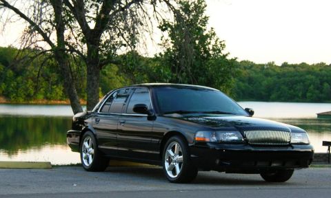 2003 Mercury Marauder - Black 2003 Mercury Marauder parked by a lake with trees in the background.