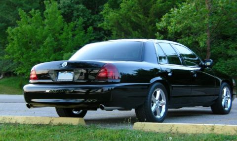 2003 Mercury Marauder - Rear view of a black 2003 Mercury Marauder sedan with chrome wheels and tinted windows.