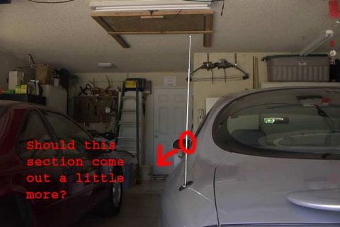 1998 Ford Taurus - A silver 1998 Ford Taurus is parked in a garage next to a red car, with tools and a ladder visible in the background.