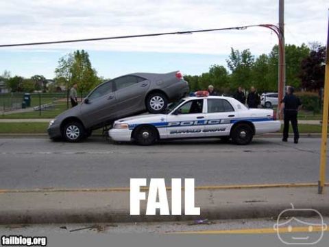 2000 Mercury Grand Marquis - A police car is stuck under a sedan after an apparent accident.
