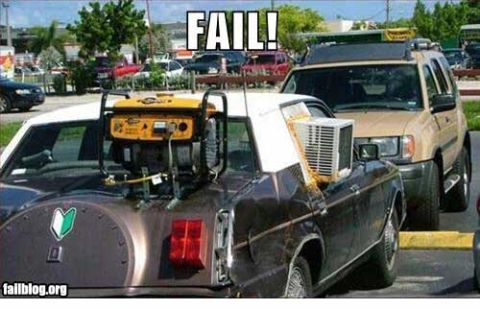 2000 Mercury Grand Marquis - A generator and air conditioner are precariously balanced on the trunk of a car.