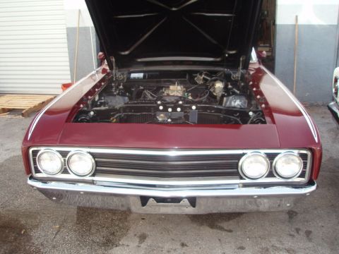 1969 Ford Torino - Front view of a maroon 1969 Ford Torino with its hood open, revealing the engine.