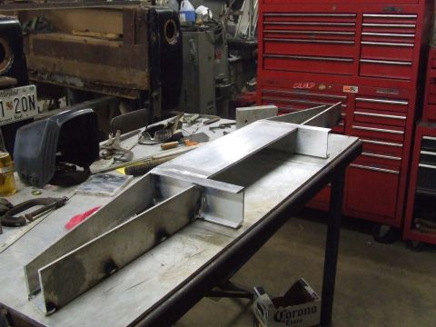 1967 Ford Bronco - Custom metal fabrication project in progress on a workbench with tools and equipment.