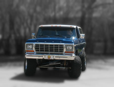 1978 Ford Bronco - Front view of a lifted 1978 Ford Bronco with large off-road tires.