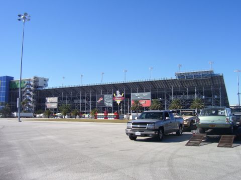 1979 Chevrolet Camaro - Daytona International Speedway scene with multiple vehicles parked in the lot.