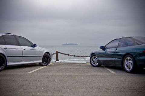 1996 Ford Probe - A 1996 Ford Probe GT is parked next to a silver sedan with the ocean and Alcatraz in the background.