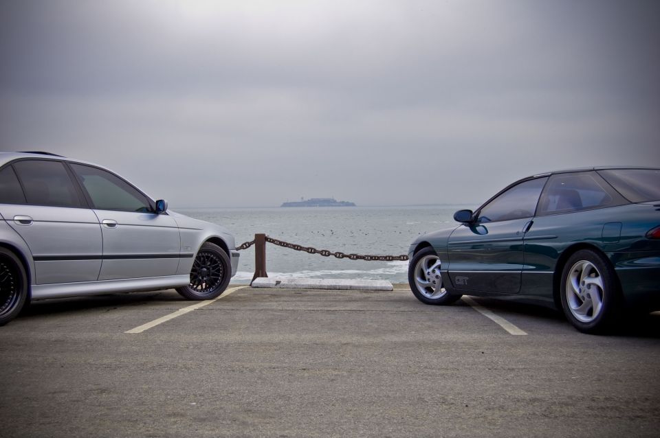 Green 1996 Ford Probe GT parked by the water