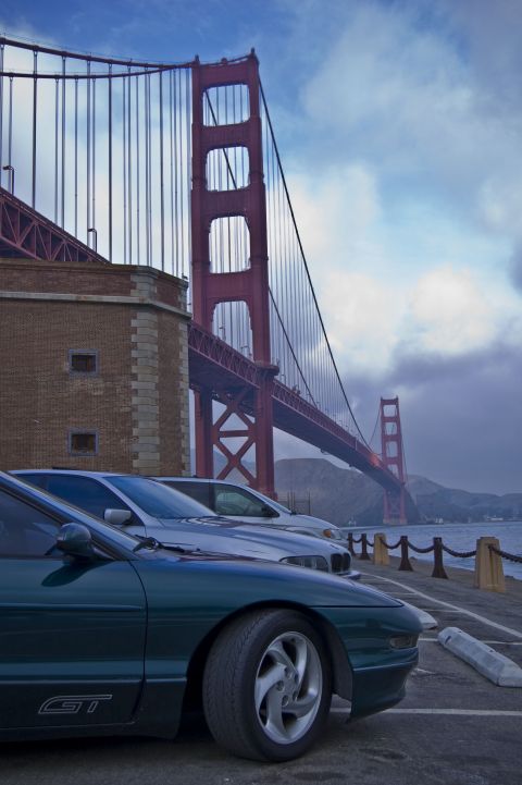 1996 Ford Probe - 1996 Ford Probe GT and another vehicle parked with the Golden Gate Bridge visible.