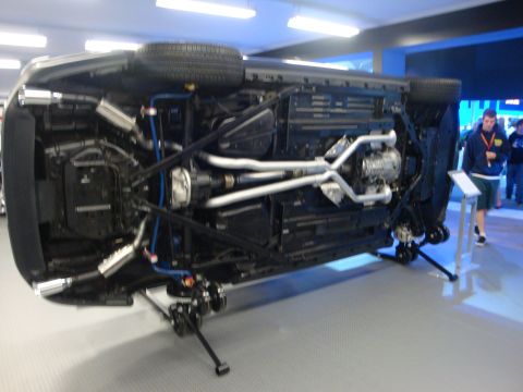 1993 Ford Taurus - The underside of a vehicle is displayed for examination at an auto show.