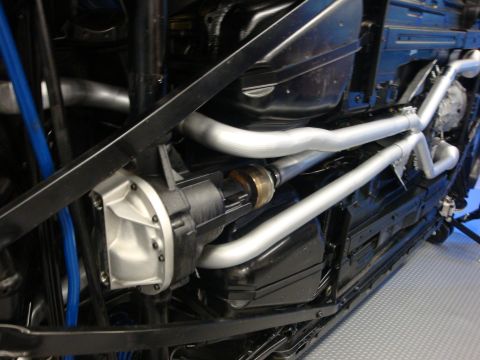 1993 Ford Taurus - Custom exhaust system and differential visible on the underbody of a car.