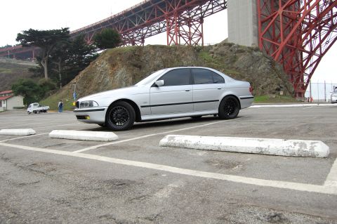 1996 Ford Probe - Silver sedan parked in a lot with a bridge in the background.