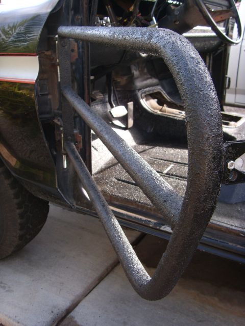 1978 Ford Bronco - Aftermarket tube doors are installed on the interior of a vehicle, with pedals and floor visible.