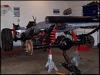 1978 Ford F-150 - The chassis of a truck is shown on jack stands, with its suspension and drivetrain components visible.