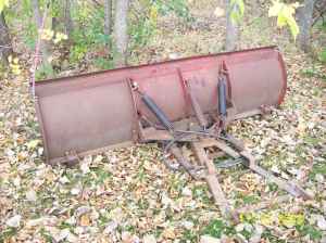 1990 Ford Bronco - A red snow plow with visible hydraulic cylinders is shown, a SuperMotors watermark.