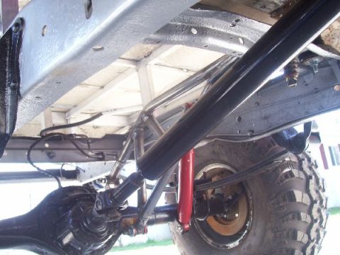 1978 Ford F-150 - Close-up of truck's rear suspension and frame components, showing the axle and shock absorber.