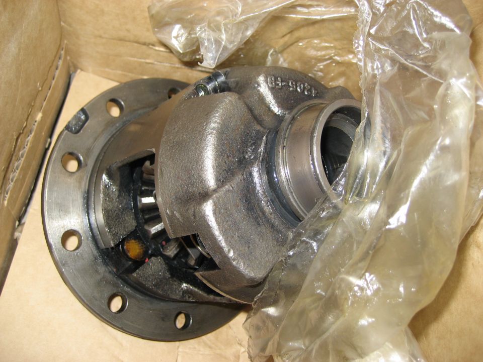 Differential part with visible gears and bolt holes, partially covered in plastic
