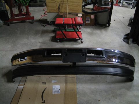 1996 Ford Bronco - Front bumper assembly with chrome accents and license plate holder.