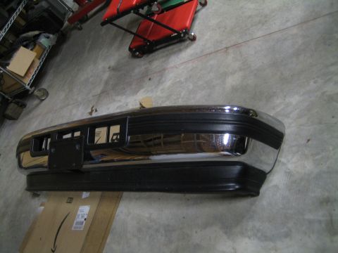 1996 Ford Bronco - A chrome and black front bumper is shown in a garage setting.
