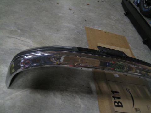 1996 Ford Bronco - A chrome bumper with black trim is shown, likely a replacement part.