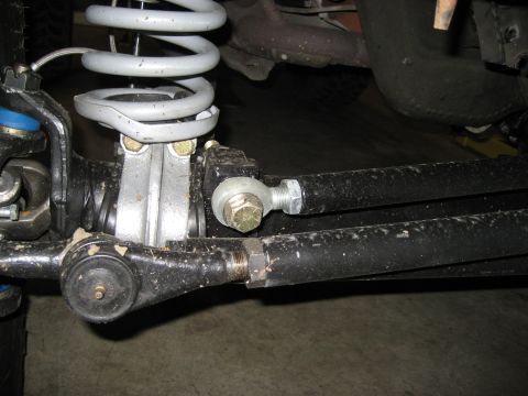 1996 Ford Bronco - Undercarriage view of a vehicle's suspension system, showing tie rods and a shock absorber.