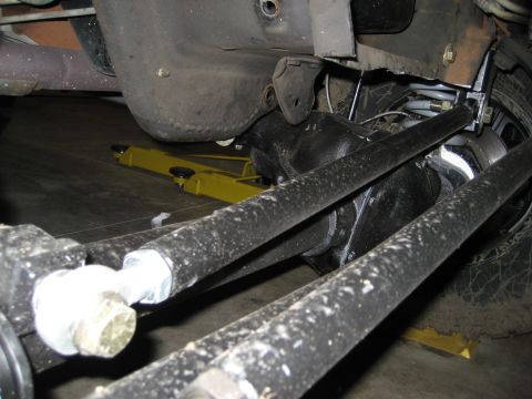 1996 Ford Bronco - Close-up view of the rear suspension and differential components of a vehicle, possibly undergoing maintenance.