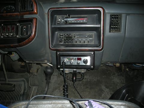 1991 Ford Bronco - Dashboard of a vehicle with multiple radio units and a CB radio installed.