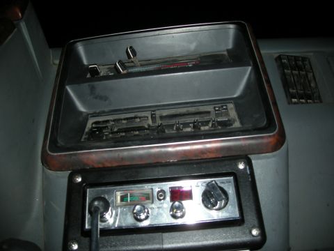 1991 Ford Bronco - The dashboard features a CB radio and a slot for a cassette player, with wood trim accents.